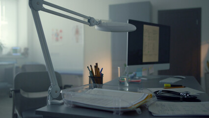 Comfortable doctor desktop closeup. Modern computer standing physician table.