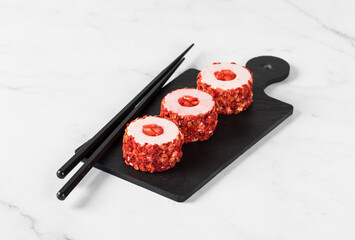 Mousse berry dessert, Sweet strawberry round sushi, on a serving board. Light background