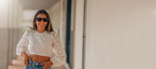 latin girl with sunglasses smiling with copy-space