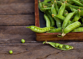 green peas on wooden background