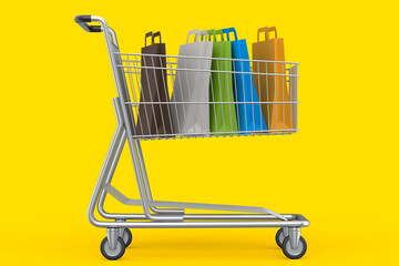 Shopping cart or trolley with shopping bag on yellow background. © Vasyl Onyskiv