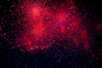 Bright fireworks of different colors and lots of bright sparks of red, blue and orange and smoke on...