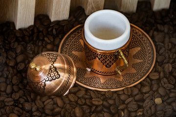 Ottoman jcoffee cup on coffee beans.