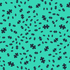 Black Puzzle pieces toy icon isolated seamless pattern on green background. Vector