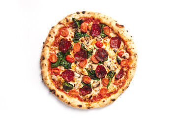 Top view of pizza topped with pepperoni, tomato, roasted garlic, mushroom and spinach on a white background