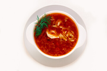 Traditional Russian cabbage soup in a ceramic bowl on a white insulated background. Flat lay.
