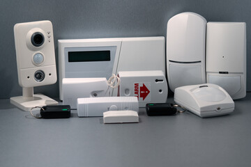 Close-up of home security equipment on gray background.