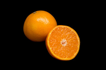 two tangerines lie on a black background