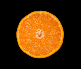 half of a mandarin is lying on a black background