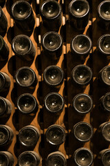 Underground wine cellar, bottles storage, bottles stacked on racks, bottle bottom