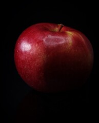 red apple on black background
