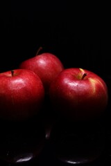 red apples on black background