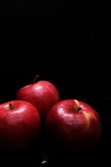 red apples on black background