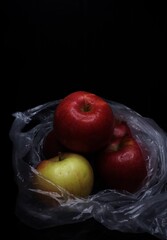 red apples in a plastic bag