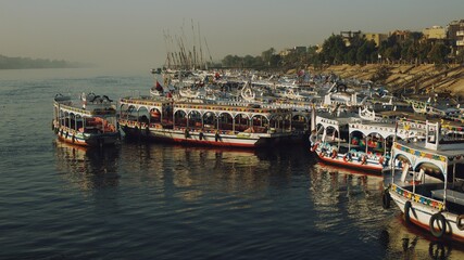 Boats for transporting tourists moored on the bank of the Nile