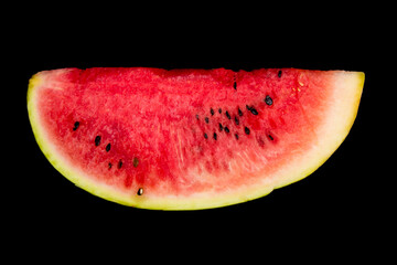 a smiling piece of watermelon lies on a black background