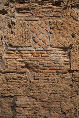 Wall of a house in the ancient city of Pompeii. Old brickwork, historical value. Antique Italy.