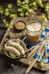 Oktoberfest set. Unfiltered beer, weisswurst, spikelets of grain, hop