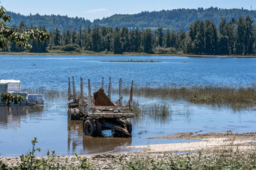 Sunken trailer and unloaded cargo in the water after the flood on the Columbia River in the...