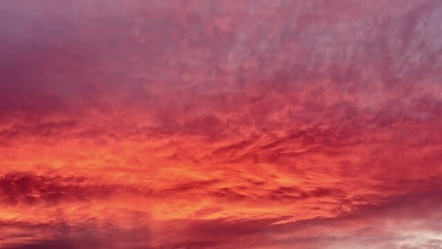 Timelapse of sunset as clouds look to be on fire as they change colors during the summer in Utah Valley.