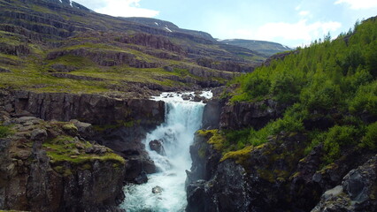 Fototapeta na wymiar natural waterfall in mountain landscape