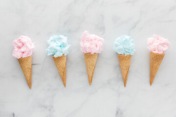 A row of waffle cones filled with cotton candy.