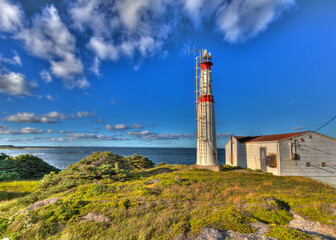 Fototapeta na wymiar fibreglass island lighthouse with ladder and clouds