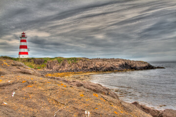 striped lighthouse on rocky coast