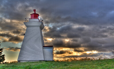 lighthouse with dramatic sunrise