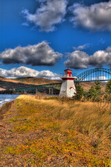 lighthouse with clouds and bridge