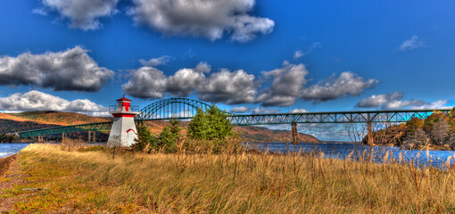 lighthouse with clouds and bridge