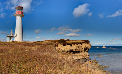 Fototapeta na wymiar lighthouse on coastal cliff