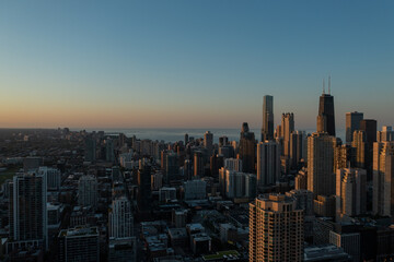 Aerial, drone view of Chicago downtown skyline and Lake Michigan during sunset 