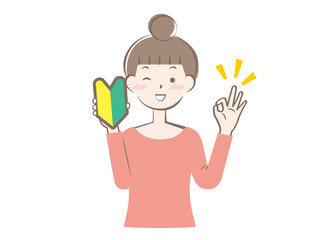 初心者マークを持った若い女性