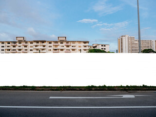 Blank template mock-up of a fenced up construction hoarding in front of housing apartment flats....