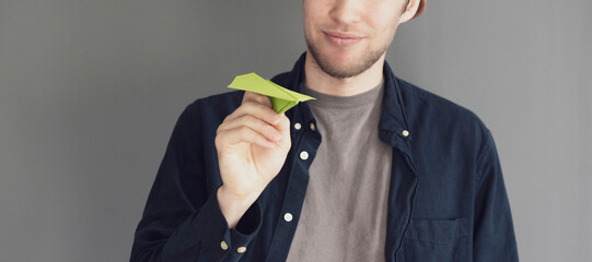 hand holding a paper plane as the sign of a dream  journey start