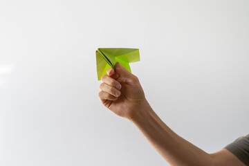 hand holding a paper plane as the sign of a dream  journey start