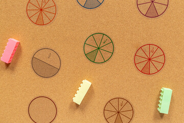 Multicolored pieces of fractions on the table. Close up math material for study. Back to school,...