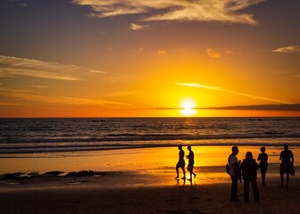 sunset on the beach with silhouettes