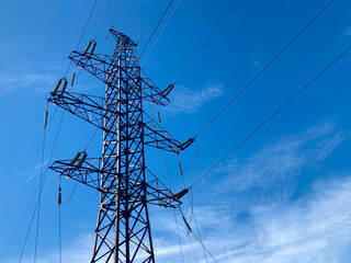 Power line support against the blue sky