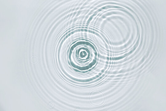 Blue water texture, surface with rings and ripples. Spa concept background. Flat lay, copy space.