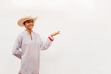 Latin teenager in the isolated white wall using traditional dress holding nothing in hand