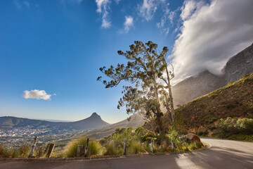 Copyspace and scenic landscape of a curved road and cloudy blue sky by Table Mountain in Cape Town,...