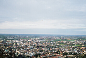 Buildings of Bergamo against the backdrop of the mountains from a bird eye view. Italy