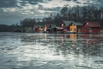 Fototapeta premium Dawn landscape of colorful houses at the lake 