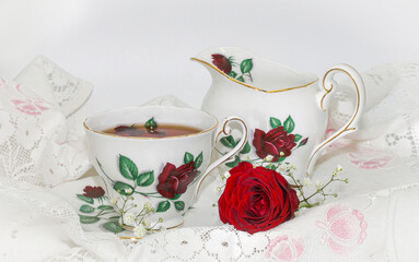 cup of tea and red rose