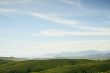 Fototapeta na wymiar A panorama of beautiful green hills. A summer landscape in the Crimea. Front view.
