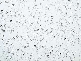 Fototapeta na wymiar Closeup raindrops on glass car in the rainy season.