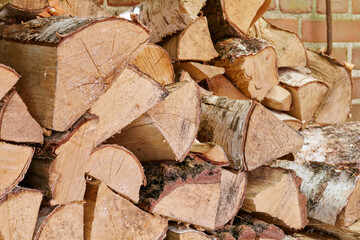 View of chopped firewood, logs stacked together in storage pile with copyspace. Closeup of wooden background and texture. Collecting dry rustic hardwood as a source of energy or to keep warm