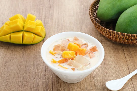 Mango Cheese Milk, a dessert made from jelly, nata de coco, basil seed, sweet mango, cream cheese and milk.
